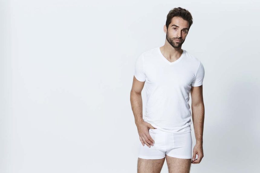 Man wearing white t-shirt and underpants, studio